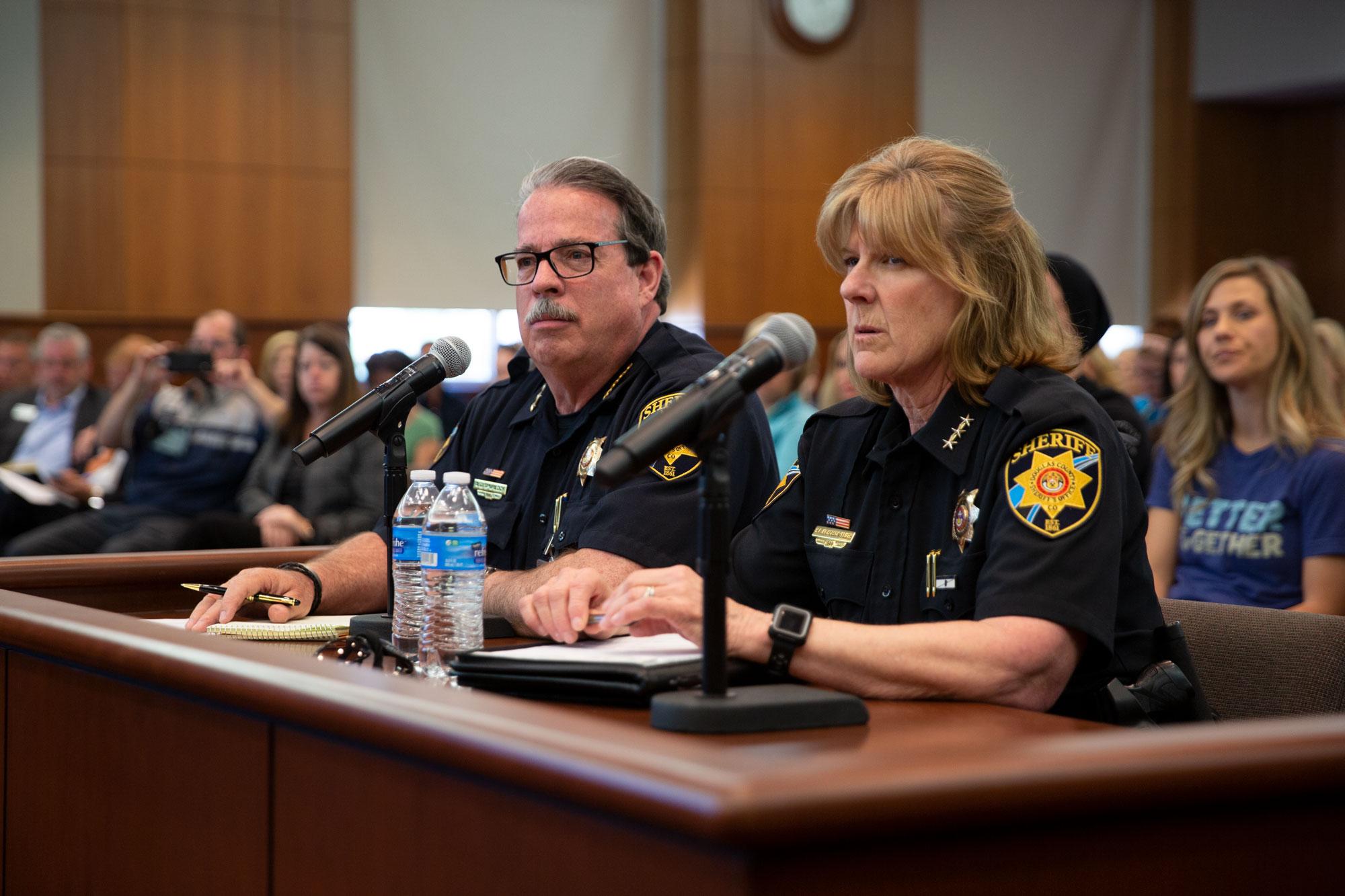Former Sheriff Tony Spurlock and former Undersheriff Holly Nicholson-Kluth at a Douglas County Commissioners meeting.